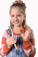 Portrait of a little cute girl with toothbrush and orthodontic appliance on white background.