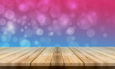 Empty wooden table with a beautiful colour bokeh background