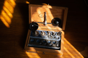 Balance scales, set of weights in box on a wooden table