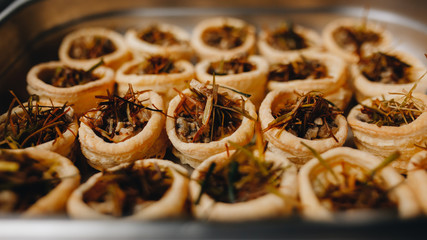 Appetizer with mushrooms and vegetables. puff pastry baskets. Catering. coffee break. close up.