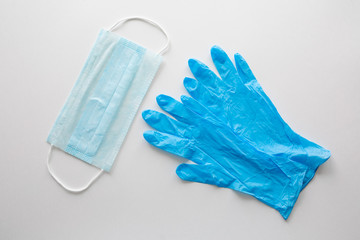 Medical gloves and a surgical face mask on a white background.Concept pandemic Covid-19, coronavirus protection