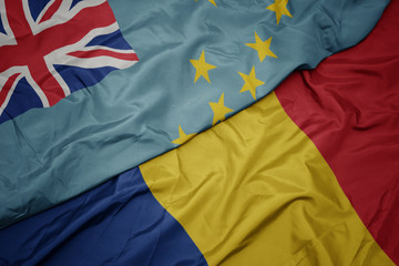 waving colorful flag of romania and national flag of Tuvalu .