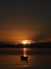 boat on watter during yellow sundown
