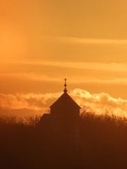 church tower on a background of an orange sky