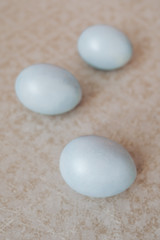 blue pearl easter eggs on a beige background, pastel colors