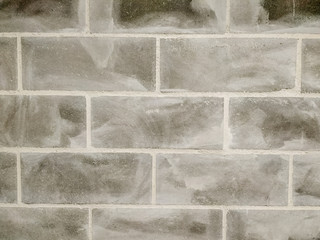 Closeup abstract pattern of cemented concrete blocks grungy textured wall background.