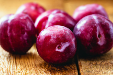 Brazilian plum on rustic wooden background, image of tropical fruit.