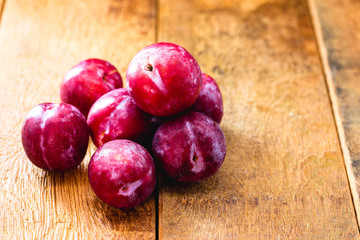 Brazilian plum on rustic wooden background, image of tropical fruit.