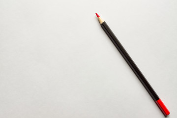 red pencil on blank white album paper. Top view. school and office supplies. Copy space.