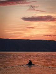 2 mans in the boat at sunset