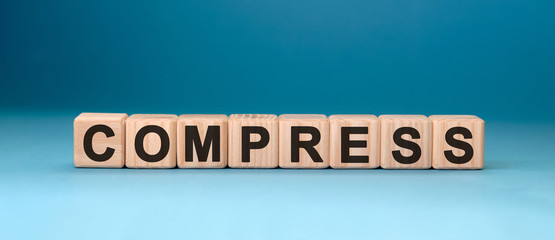 COMPRESSword cube on a blue background. Medical concept.