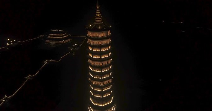 Night Aerial Circle Descending Approach Shot of Xa Loi stupa at Bai Dinh Temple Spiritual and Culture Complex in Ninh Binh Vietnam, the largest spiritual tourist place in Vietnam