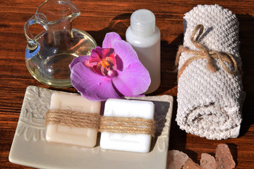 Obraz na płótnie Canvas towel and hand-made soaps next to the purple orchid