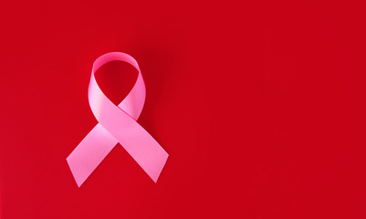 Pink symbol tape - breast cancer problem - on a red background