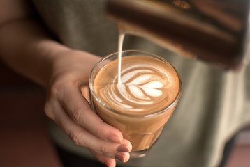 Pouring latte art on flat white
