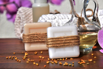 handmade soaps with pollen next to purple orchids