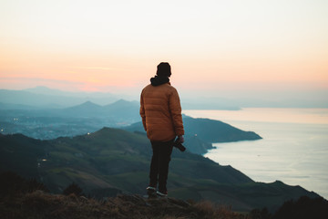 Fototapeta premium Photographer on top of a hill admiring the landscape in Jaizkibel, Basque Country