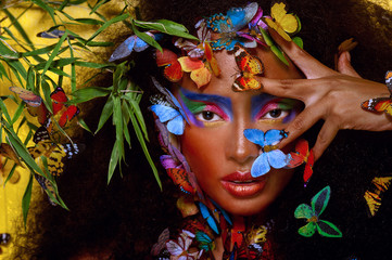 beautiful african girl surrounded by butterflies