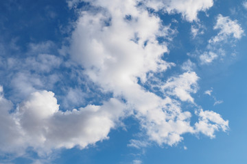Cumulus clouds on blue sky in sunny spring day, nature background.