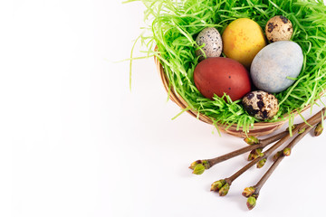 happy Easter. colored Easter eggs in a nest on a white background. Happy Easter card
