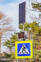Solar cells and traffic light by the crossroad.
