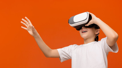 Emotional teenager enjoying virtual reality glasses, panorama