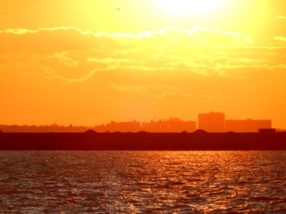 Dramatic Vivid Orange and Yellow Sunset Water Skyline
