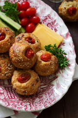 Muffins with cheese, cottage cheese and tomatoes, vegetables and cheese served with wine.
