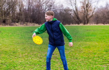 Teenager playing frisbee in the park