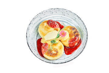 dessert on a plate pancakes with powdered sugar and fruit on a white background