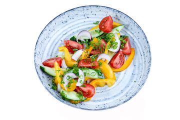 vegetable salad with fresh vegetables on a plate on a white background