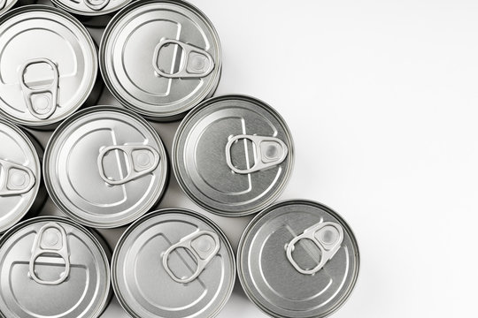 Top view of various cans of food stored at home for use, for example, in times of quarantine by Coronavirus Covid-19. White background. Space for text.