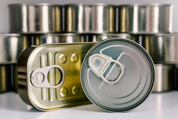 Close-up of various cans of food stored to keep enough food at home, for example, in times of...