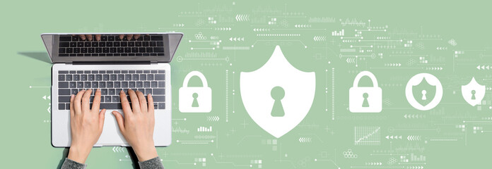 Cyber security theme with person using a laptop computer