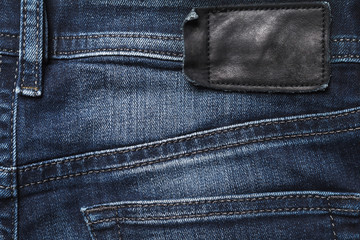 Jeans back side texture with black leather label
