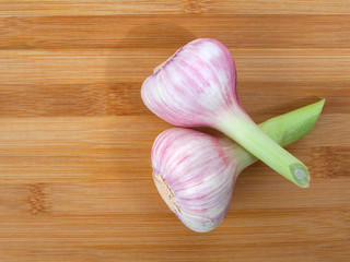 Close up of garlic bulbs on wooden background