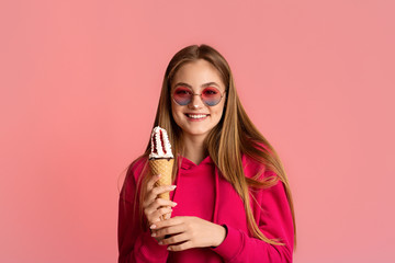 Girl in round glasses with smeared nose in ice cream