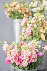 Bouquet of Beautiful pink, white, green color eustoma in vase . Spring flowers in the cold room of the flower shop.