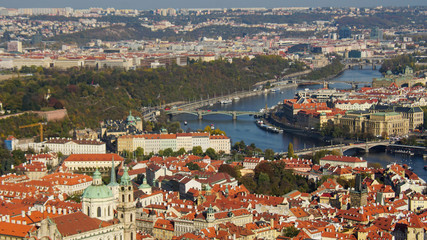 Naklejka na ściany i meble Beautiful view of Prague from the highest part of the city. Sunny weather, bright sky and river. Tile roofs glisten in the sun.