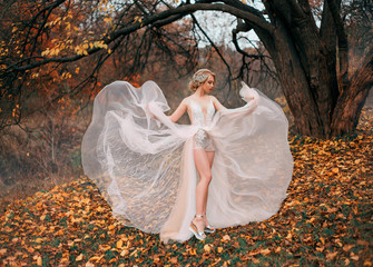 Beautiful young woman dancing backdrop autumn yellow leaves. Fairytale princess enjoy nature...