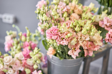 Bouquet of Beautiful pink, white, green color eustoma in vase . Spring flowers in the cold room of the flower shop.