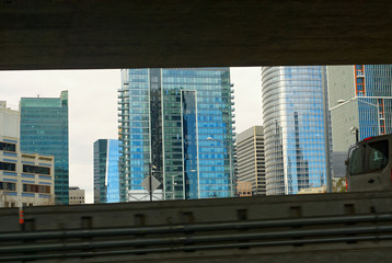 A section of the San Francisco skyline framed by the Bay Bridge decks.