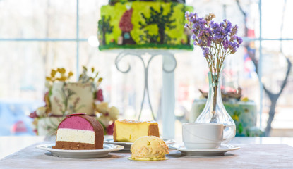 Bouchee dessert, Lady dessert and caramel cheesecake, fruit tea on the table. Sweets with tea.