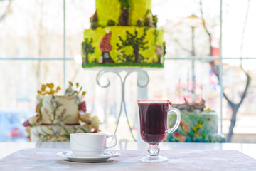 Fruit tea and mulled wine on a table in a coffee shop. Two drinks - healthy and not healthy.