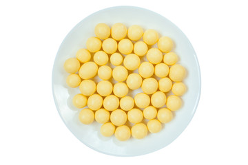 tasty appetizing sweets in white chocolate on a plate on  white table