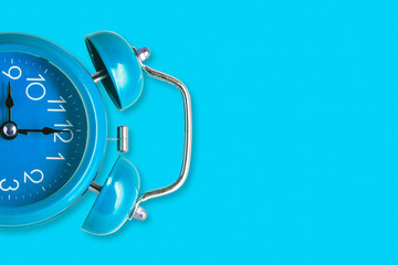 Blue  alarm retro clock on blue background.
