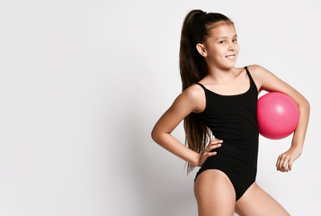 Fototapeta na wymiar girl gymnast trains with a gymnastic ball . children professional sports. rhythmic gymnastics.