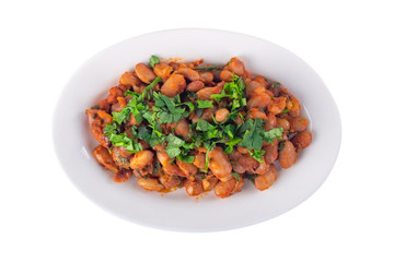 Lobio is a Georgian dish and parsley in a plate isolated on white, top view