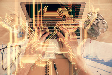 Double exposure of man's hands typing over computer keyboard and tech theme hologram drawing. Top view. Technology concept.