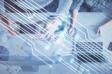 Double exposure of man and woman working together and data theme hologram drawing. Computer background. Top View.